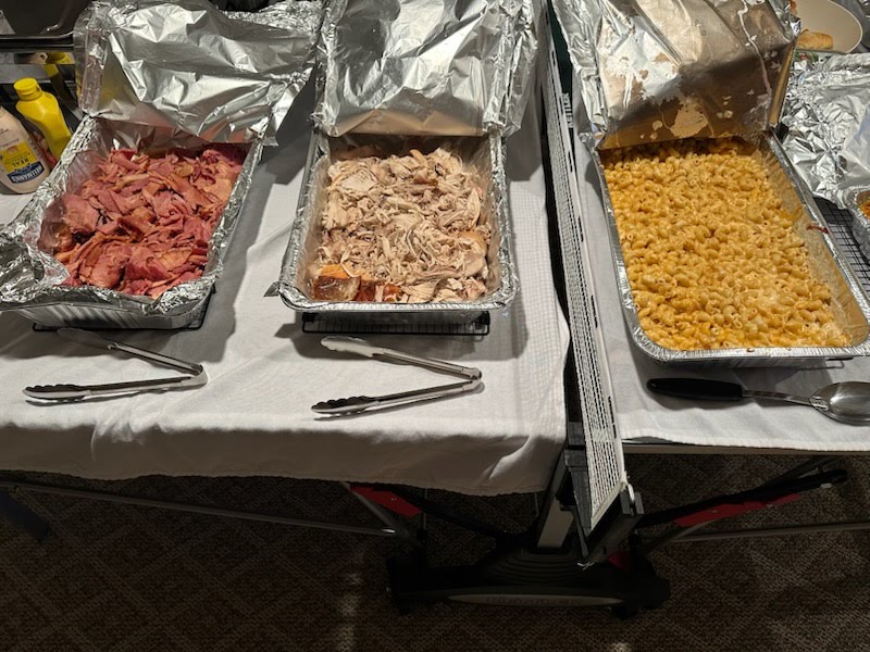 Catering spread with pulled pork, chicken, and mac and cheese